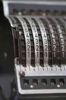 Close up detailed view of historical old calculator with small iron buttons.