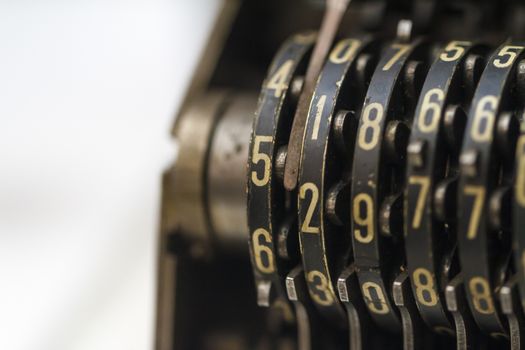 Close up detailed view of historical old calculator with small iron buttons.