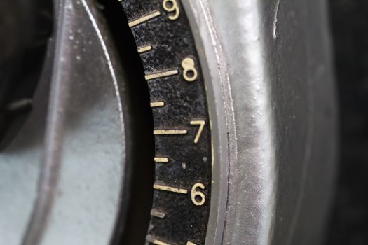 Close up detailed view of historical old calculator with small iron buttons.