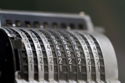 Close up detailed view of historical old calculator with small iron buttons.
