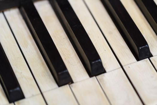 Close up detailed view of historical old piano with white and black buttons.