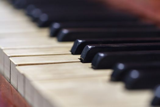 Close up detailed view of historical old piano with white and black buttons.