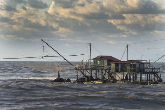 Traditional wooden buildings for fishing situated on the estuary of the River Arno Tuscany Italy.