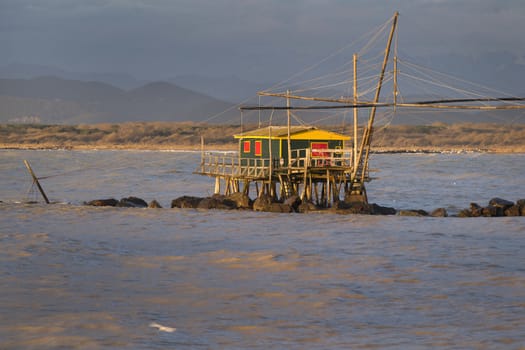 Traditional wooden buildings for fishing situated on the estuary of the River Arno Tuscany Italy.