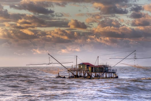 Traditional wooden buildings for fishing situated on the estuary of the River Arno Tuscany Italy.