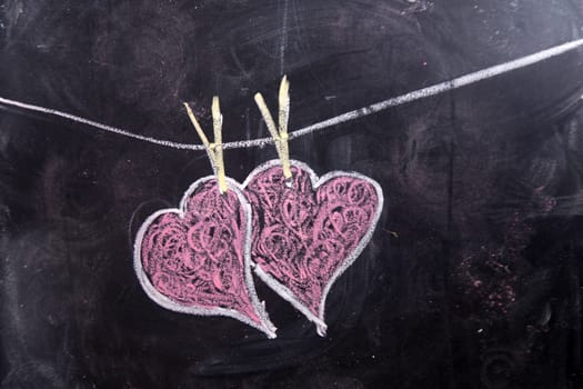 Done graphical representation with chalk on blackboard symbol of love, the heart