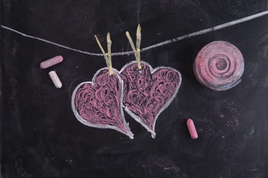 Done graphical representation with chalk on blackboard symbol of love, the heart