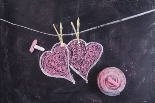 Done graphical representation with chalk on blackboard symbol of love, the heart