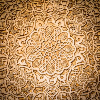 Wall detail of Alhambra UNESCO site in Granada - South of Spain. 600 years old arabic characters.