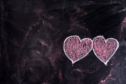 Done graphical representation with chalk on blackboard symbol of love, the heart