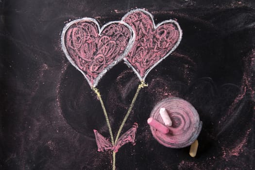Done graphical representation with chalk on blackboard symbol of love, the heart