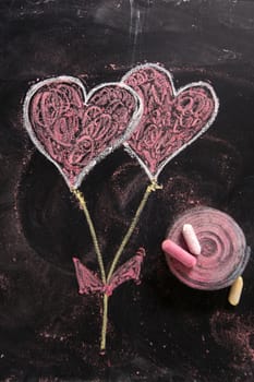 Done graphical representation with chalk on blackboard symbol of love, the heart