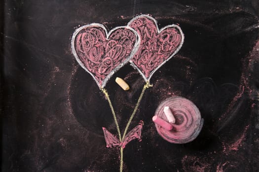 Done graphical representation with chalk on blackboard symbol of love, the heart