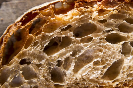 Slice of whole wheat bread on sourdough-border cooked in a wood oven