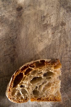 Slice of whole wheat bread on sourdough-border cooked in a wood oven