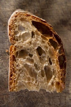 Slice of whole wheat bread on sourdough-border cooked in a wood oven