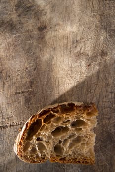 Slice of whole wheat bread on sourdough-border cooked in a wood oven