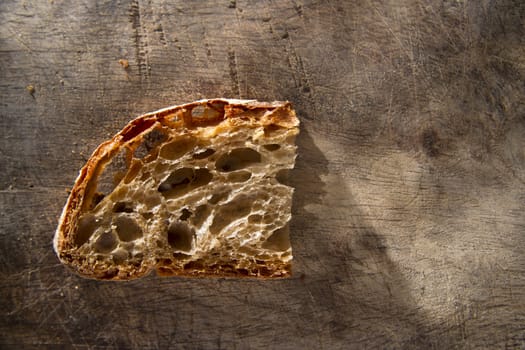 Slice of whole wheat bread on sourdough-border cooked in a wood oven