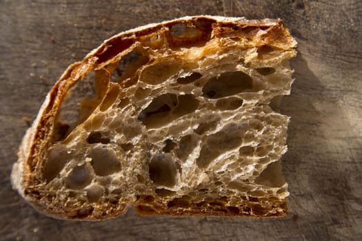 Slice of whole wheat bread on sourdough-border cooked in a wood oven