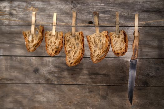 Slice of whole wheat bread sourdough baked in a wood oven hanging