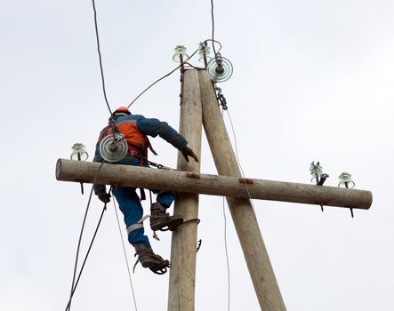 electrician working on the power lines after the accident
 with the use of special tools
