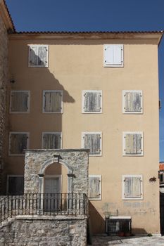 Old house, windows with shutters and stone arc, Budva, Montenegro