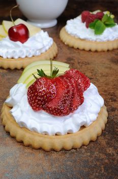 Tartlets filled   whipped cream and apples with raspberries