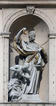 Statue of Saint on baroque Jesuits church. The church was built between 1623 and 1627. in Vienna, Austria