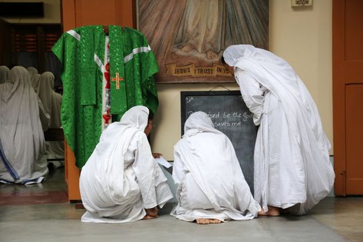 Sister of Missionaries of Charity preparing for prayer in Motherhouse, Kolkata, India