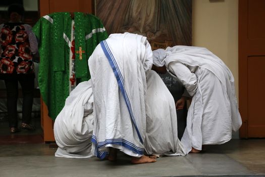 Sister of Missionaries of Charity preparing for prayer in Motherhouse, Kolkata, India