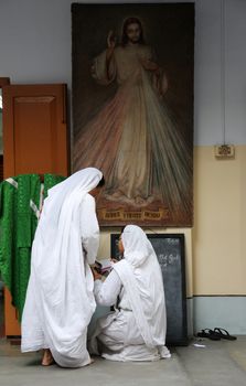 Sister of Missionaries of Charity preparing for prayer in Motherhouse, Kolkata, India