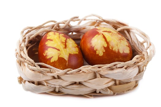 Easter eggs with a pattern in the basket isolated