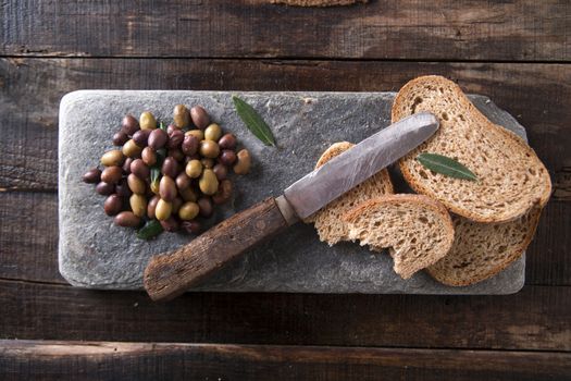 Aperitif made of bread with mixed olives in brine of Tuscany Italy
