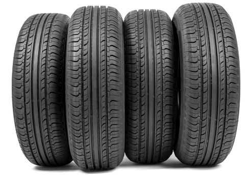 Complete set of new tyres for car on white background