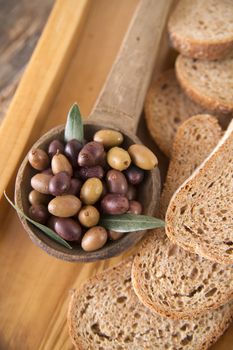 Aperitif made of bread with mixed olives in brine of Tuscany Italy
