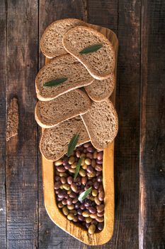 Aperitif made of bread with mixed olives in brine of Tuscany Italy
