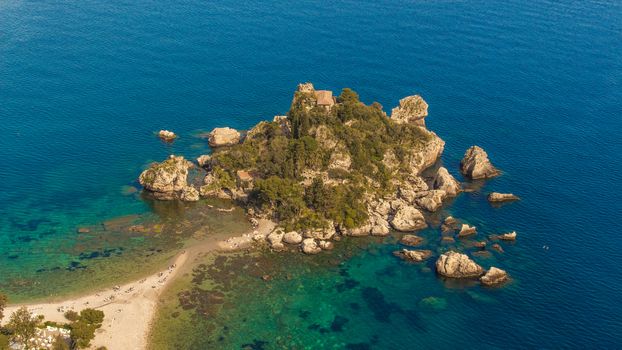 Aerial view of Isola Bella's island and beach on blue ocean water in Taormina - Sicily.