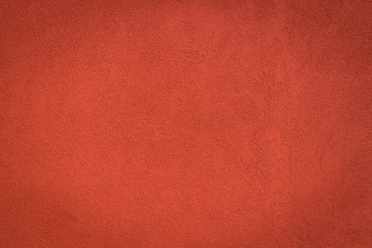 Red wall background and texture with vignetting and blank copyspace for text or advertising.