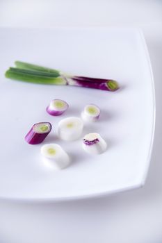 Presentation of pieces of red onion of Tropea on a plate