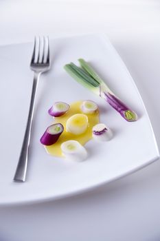 Presentation of pieces of red onion of Tropea on a plate