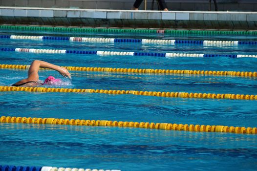 Girl swimmer in the outdoor swimming pool