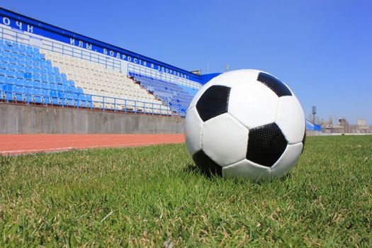 Football on a grass lawn of sports stadium