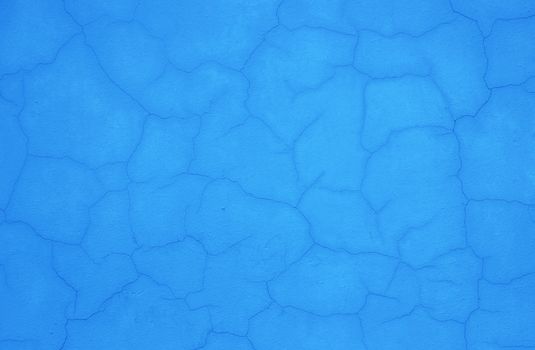 Texture of outside blue stucco wall of a house.