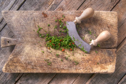 Preparation of chopped chives and chili on wooden-border