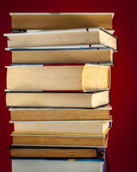 A pile of old books on a colored background