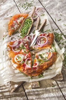 Freshly baked pizza with red onion and mozzarella 