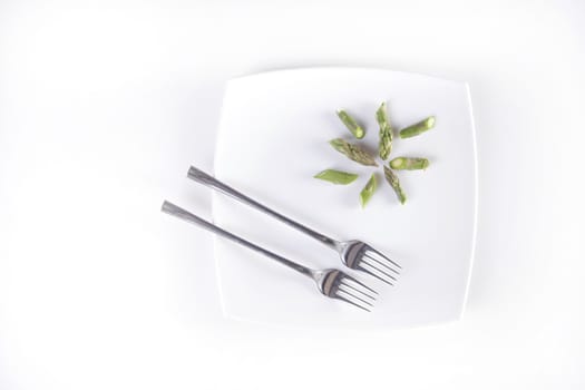 Presentation of raw asparagus spears on a white background