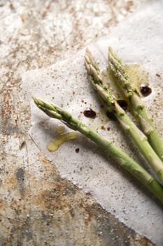 Presentation of some raw asparagus on metal background