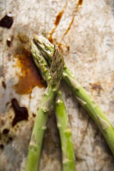 Presentation of some raw asparagus on metal background