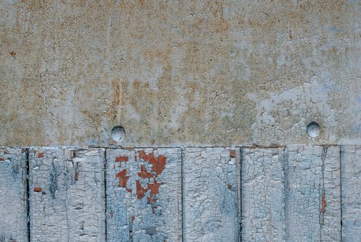 the door of planks covered with sheets of rusty metal, chipped old paint, which has long been under the influence of various climatic conditions